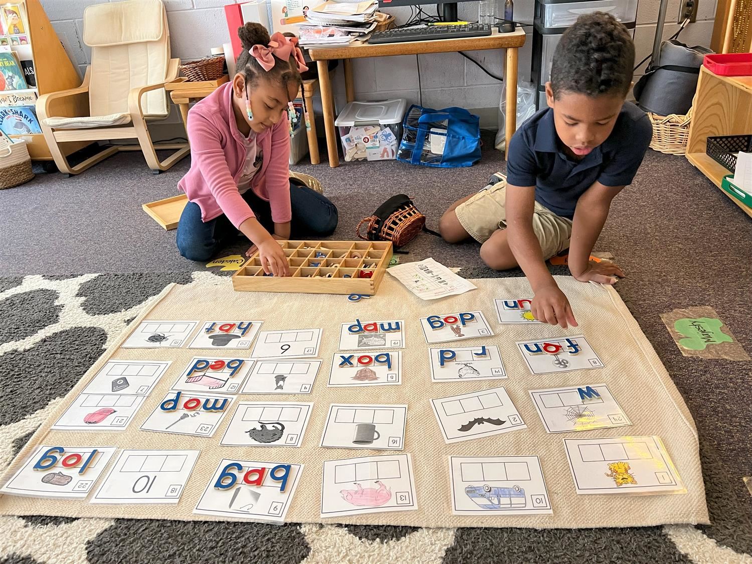 Two young students working on a phonics sorting activity Two young students working on a phonics sorting activity